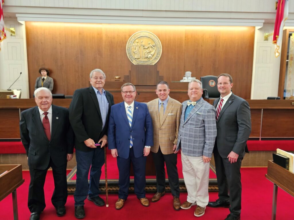 Dr. Hurst and CCC Trustees pose with Speaker Tim Moore in the General Assembly's chamber during community college day.