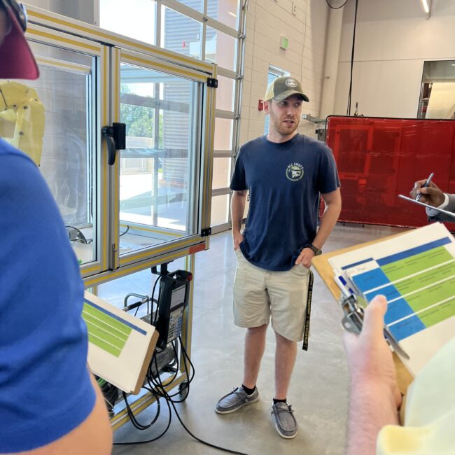 Nate Dixon talks with judges during the year-end robot programming competition.