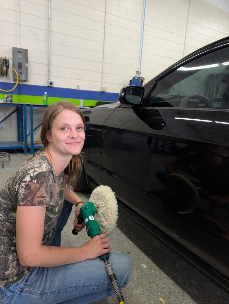 Miranda Parks working on her car.