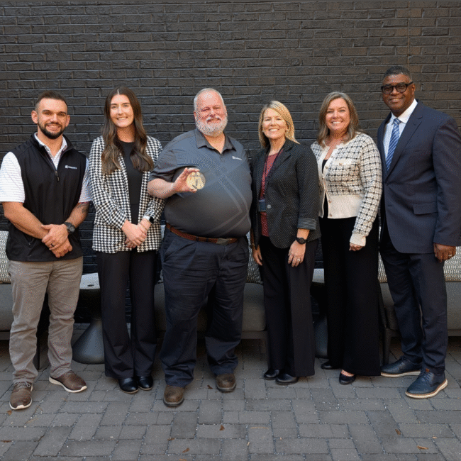 CCC and Greenheck represented pose with the award.