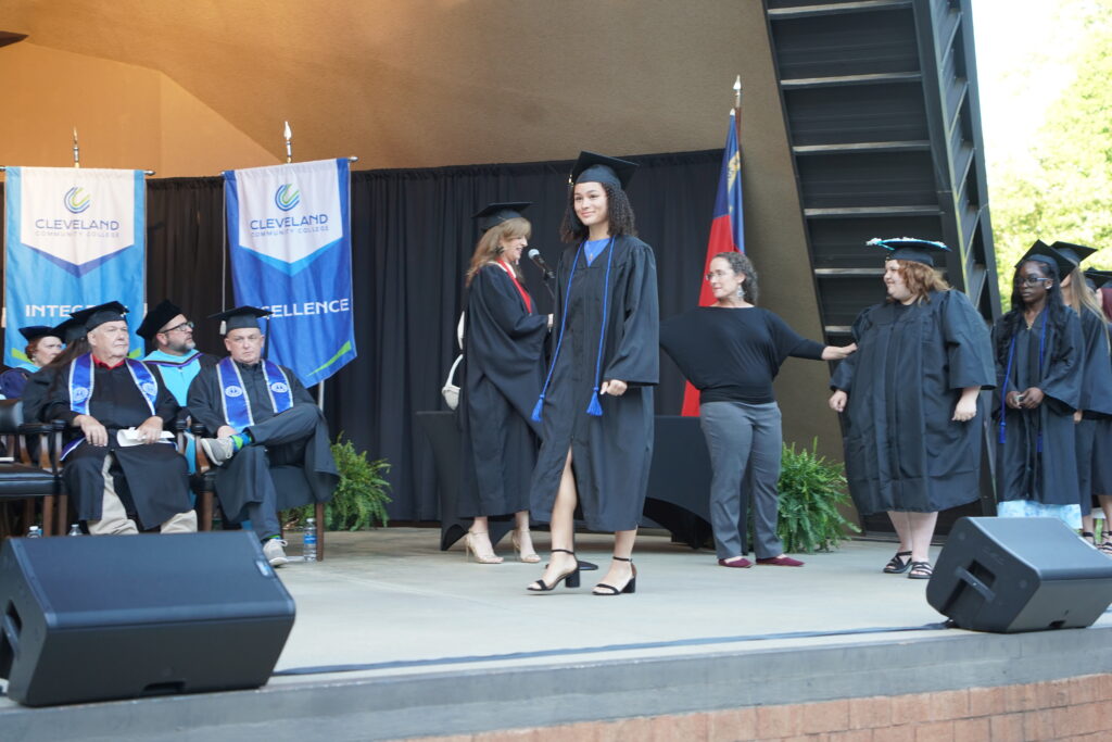 Lillianna Scott walks across the stage at CCC's commencement ceremony.