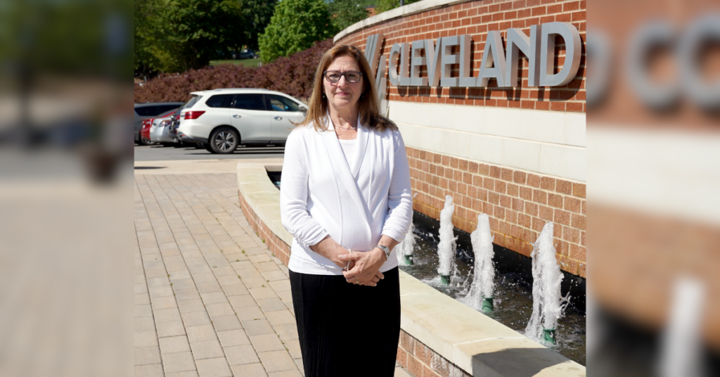 Fran Musolino poses in front of the fountain on campus.