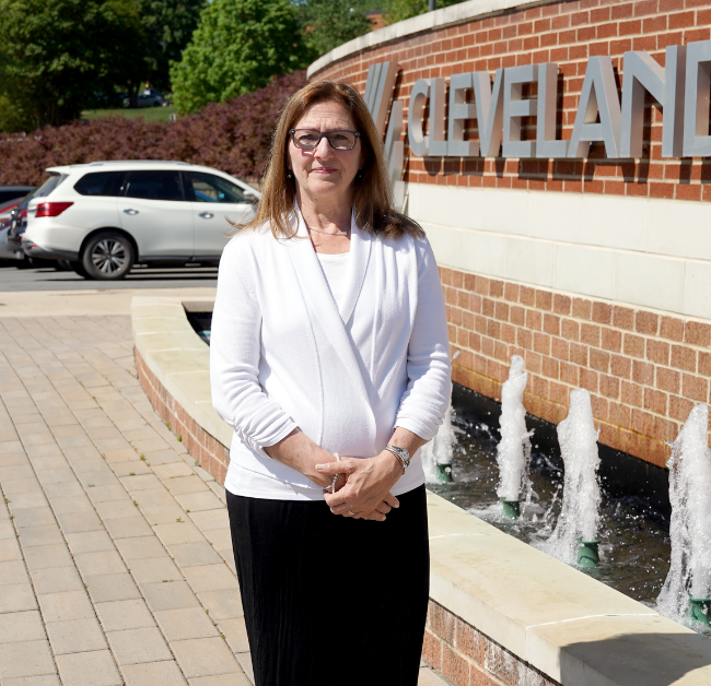 Fran Musolino poses in front of the fountain on campus.