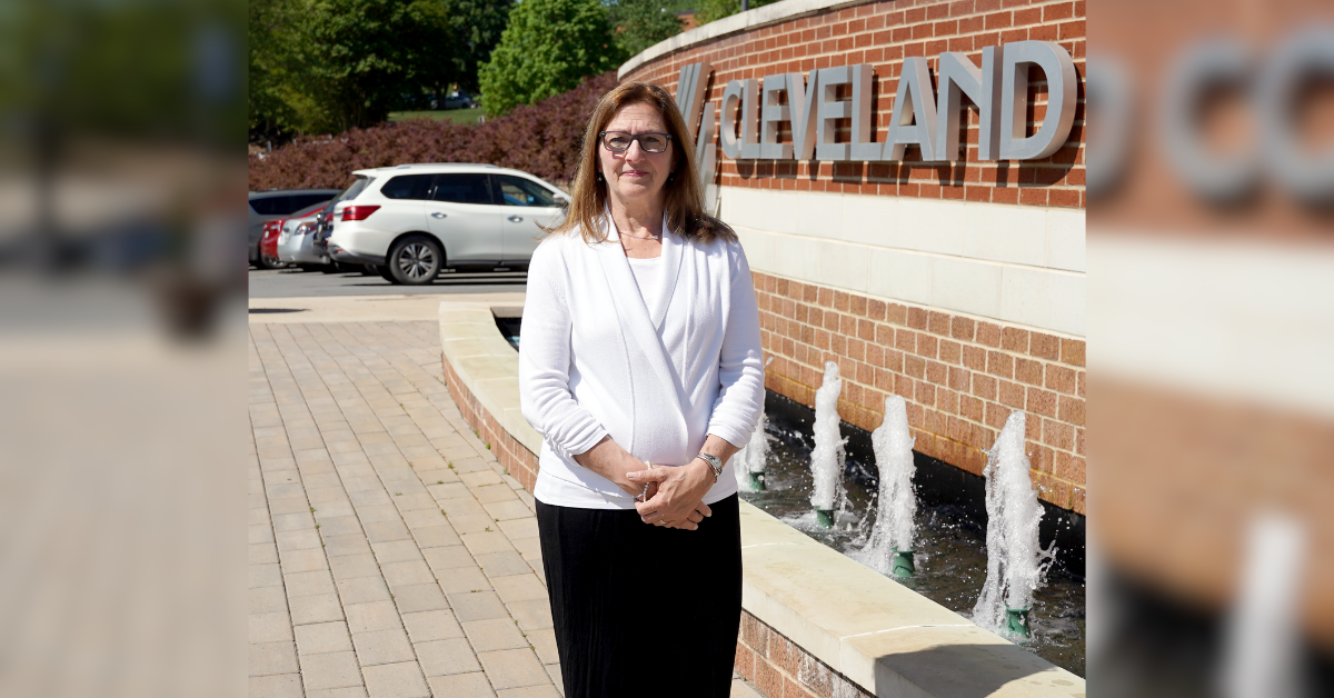 Fran Musolino poses in front of the fountain on campus.