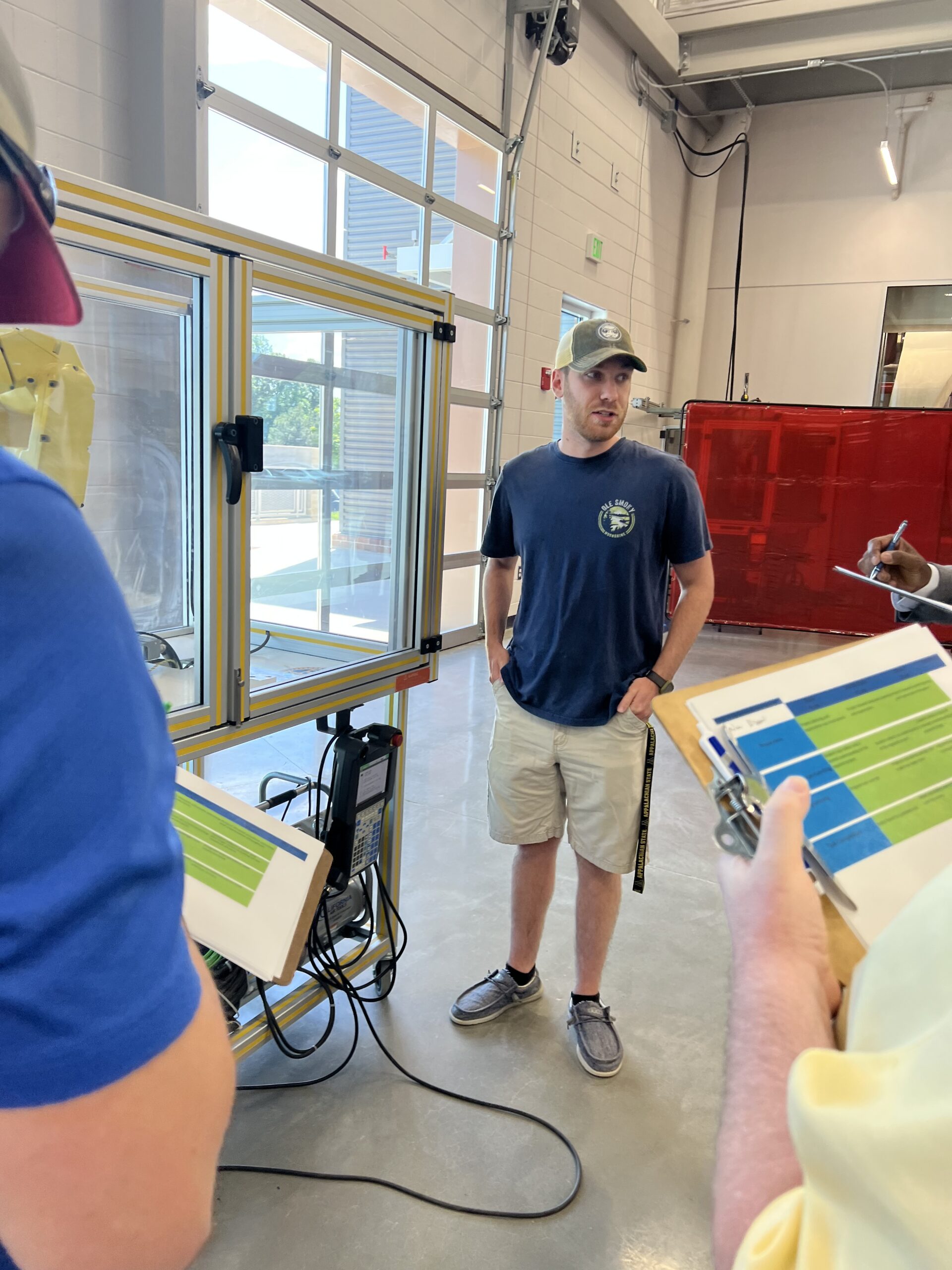 Nate Dixon talks with the judges during the Robot Programming class's year-end competition.